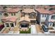 Two-story home with a stone accent front porch and desert landscaping in a dense suburban neighborhood at 7694 Hampton Park Ln, Las Vegas, NV 89113