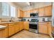 Well-equipped kitchen with stainless steel appliances and oak cabinets, perfect for cooking and entertaining at 7694 Hampton Park Ln, Las Vegas, NV 89113