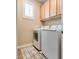 Laundry room featuring newer washer and dryer, window, and vinyl flooring at 7694 Hampton Park Ln, Las Vegas, NV 89113