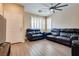 Bright living room featuring tile floors, white shutters, and a comfortable leather reclining sofa set at 7694 Hampton Park Ln, Las Vegas, NV 89113