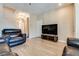 Inviting living room featuring tile floors, neutral walls, and a comfortable leather reclining sofa set at 7694 Hampton Park Ln, Las Vegas, NV 89113