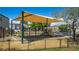 Neighborhood playground with shade structure, swings, and a slide at 7694 Hampton Park Ln, Las Vegas, NV 89113