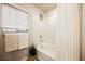 Bathroom featuring a shower-tub combo, bright natural light, and a neutral color palette at 8113 Misty Canyon Ave, Las Vegas, NV 89113