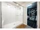 This bathroom showcases a modern walk-in shower and leads to a spacious, organized walk-in closet at 8113 Misty Canyon Ave, Las Vegas, NV 89113