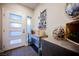 A stylish entryway features a modern door, mirrored console table, and unique decor at 8113 Misty Canyon Ave, Las Vegas, NV 89113