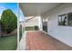 Covered patio with brick flooring, perfect for outdoor living, featuring lush landscaping at 8389 Charlton Valley Ct, Las Vegas, NV 89123