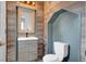 Stylish half-bathroom with wood accent wall, modern vanity, and charming design at 8389 Charlton Valley Ct, Las Vegas, NV 89123