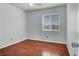 Bedroom with hardwood floors, ceiling fan and a window allowing plenty of sunlight at 8389 Charlton Valley Ct, Las Vegas, NV 89123
