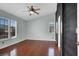 Spacious bedroom with hardwood floors, natural light, and ceiling fan at 8389 Charlton Valley Ct, Las Vegas, NV 89123
