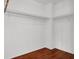 A view of a walk-in closet with white walls and wood flooring at 8389 Charlton Valley Ct, Las Vegas, NV 89123