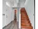 Inviting entryway with hardwood floors, a modern staircase, and a convenient first-floor powder room at 8389 Charlton Valley Ct, Las Vegas, NV 89123