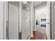 Bathroom with a shower featuring white tile, a clear glass shower door, and modern fixtures at 8780 Autumn Wreath Ave, Las Vegas, NV 89129