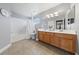Bright bathroom features double vanity, tub with shower, and large mirror at 8780 Autumn Wreath Ave, Las Vegas, NV 89129