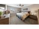 Bedroom with light, neutral walls and carpeting, a ceiling fan, and shuttered windows at 8780 Autumn Wreath Ave, Las Vegas, NV 89129