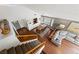 Upstairs view of open-concept living room boasts hardwood floors and large windows at 8780 Autumn Wreath Ave, Las Vegas, NV 89129