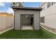 Storage shed with roll up door, side access door, and interior lighting at 8780 Autumn Wreath Ave, Las Vegas, NV 89129