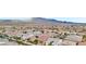 Expansive aerial view of a vibrant residential community nestled against a stunning mountain backdrop at 8956 Skye Treeline St, Las Vegas, NV 89166