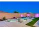 Beautiful backyard pool and spa with ambient lighting, creating a relaxing and inviting outdoor space at 8956 Skye Treeline St, Las Vegas, NV 89166