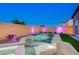 Amazing backyard featuring a modern pool, spa with elegant lighting, creating a relaxing outdoor space at 8956 Skye Treeline St, Las Vegas, NV 89166
