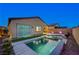 Serene backyard featuring a sleek pool, spa, and artificial turf, ideal for outdoor enjoyment at 8956 Skye Treeline St, Las Vegas, NV 89166