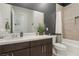 Modern bathroom with dark brown cabinets, white countertops, and tiled shower/tub combo at 8956 Skye Treeline St, Las Vegas, NV 89166