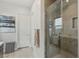 A modern bathroom features a glass-enclosed shower with built-in seating and sleek fixtures at 8956 Skye Treeline St, Las Vegas, NV 89166