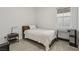 Minimalist bedroom featuring a simple design, a cozy bed, and a compact workspace by the window at 8956 Skye Treeline St, Las Vegas, NV 89166