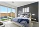 Bright bedroom featuring a modern design, large windows, and a view of the outdoor water feature at 8956 Skye Treeline St, Las Vegas, NV 89166