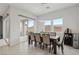 Bright dining area featuring modern lighting, a wine cooler, and access to outdoor patio at 8956 Skye Treeline St, Las Vegas, NV 89166