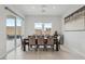 Elegant dining room with modern lighting, a large table, and sliding glass doors to the backyard at 8956 Skye Treeline St, Las Vegas, NV 89166