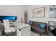 A modern home office features a comfortable sofa, a spacious desk, and ample natural light at 8956 Skye Treeline St, Las Vegas, NV 89166