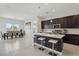 Open-concept kitchen with a large island, stainless steel appliances, and pendant lighting, ideal for gatherings at 8956 Skye Treeline St, Las Vegas, NV 89166