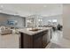 Spacious kitchen with a central island, seamlessly connecting to the living and dining areas for easy entertaining at 8956 Skye Treeline St, Las Vegas, NV 89166