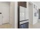 Modern kitchen showcasing a stainless steel refrigerator, white door, and contemporary wall decor at 8956 Skye Treeline St, Las Vegas, NV 89166