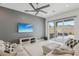 Stylish living room with a flat-screen TV, cozy seating, and sliding doors to the outdoor patio at 8956 Skye Treeline St, Las Vegas, NV 89166
