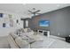 Spacious living room with a ceiling fan, comfortable seating, and stylish wall art at 8956 Skye Treeline St, Las Vegas, NV 89166