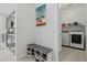 A mudroom provides seating and storage, seamlessly connecting to the kitchen and laundry area at 8956 Skye Treeline St, Las Vegas, NV 89166