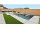 Backyard pool with waterfall feature, artificial turf, and outdoor seating area at 8956 Skye Treeline St, Las Vegas, NV 89166