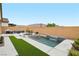 Inviting backyard pool with modern waterfall feature, lounge chair, and outdoor seating at 8956 Skye Treeline St, Las Vegas, NV 89166