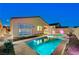 Backyard oasis with a pool, spa, waterfall feature and a lounge chair provides a luxurious outdoor retreat at 8956 Skye Treeline St, Las Vegas, NV 89166