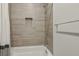 Tiled shower/tub combo with a built-in shelf at 8956 Skye Treeline St, Las Vegas, NV 89166