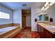 Bright bathroom with a tiled shower, soaking tub, and double vanity at 9209 Tudor Park Pl, Las Vegas, NV 89145