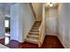 Inviting entryway showcasing hardwood floors, a staircase with wood railings, and neutral-toned walls at 9209 Tudor Park Pl, Las Vegas, NV 89145