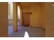 Covered entryway with an arched doorway and decorative wall sconce at 9209 Tudor Park Pl, Las Vegas, NV 89145