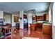 Open kitchen with stainless steel appliances, center island, and hardwood floors at 9209 Tudor Park Pl, Las Vegas, NV 89145