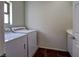 Well-lit laundry room equipped with a washer, dryer, window, and a utility sink at 9209 Tudor Park Pl, Las Vegas, NV 89145
