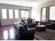 Spacious living room featuring hardwood floors and comfortable leather furniture at 9209 Tudor Park Pl, Las Vegas, NV 89145