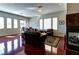 Open-concept living room with fireplace, lots of light and hardwood floors at 9209 Tudor Park Pl, Las Vegas, NV 89145