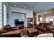 Cozy living room with a fireplace, comfortable seating, and hardwood floors at 9209 Tudor Park Pl, Las Vegas, NV 89145