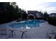 Inviting community pool with lounge chairs and mature trees, perfect for relaxation at 9209 Tudor Park Pl, Las Vegas, NV 89145